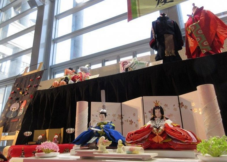 畳縁や学生服などで仕立てた人形が並ぶ「産業お雛さま展」＝児島市民交流センター