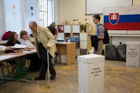 　スロバキアの首都ブラチスラバの投票所で、投票用紙を受け取る男性＝９月３０日（ゲッティ＝共同）