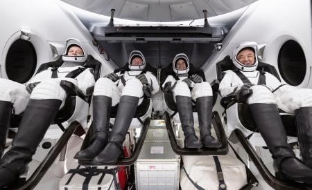 　国際宇宙ステーションから帰還し、ハッチが開いた宇宙船クルードラゴンの中で笑顔を見せる古川聡飛行士（右端）ら＝１２日、米フロリダ州沖（ＮＡＳＡ提供・共同）