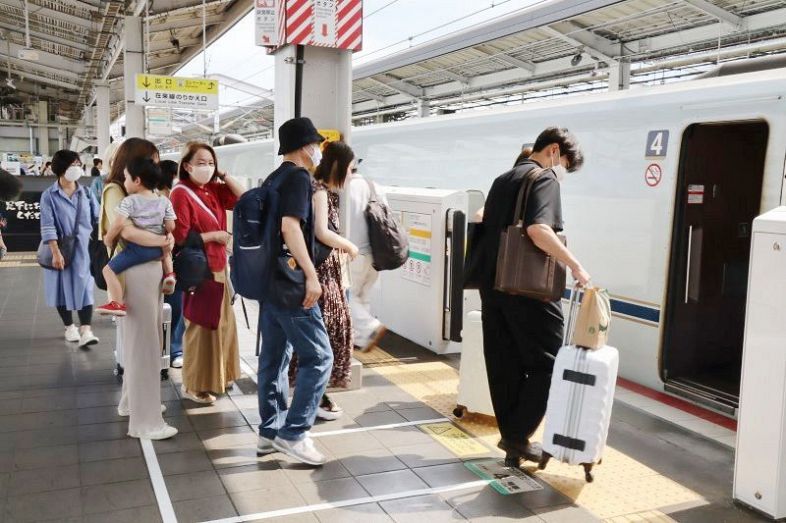 新幹線に乗り込む帰省客ら＝１４日午前１０時１分、ＪＲ岡山駅