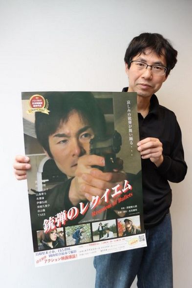自主製作映画「銃弾のレクイエム」のポスターを手にする名和さん