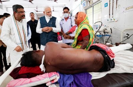 　３日、インド東部オディシャ州の病院で、列車事故の負傷者を見舞うモディ首相（中央）（インド政府提供・ロイター＝共同）