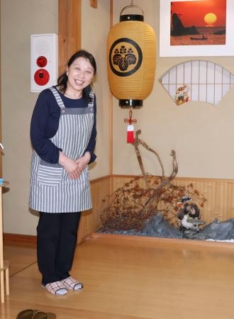 　民宿の玄関で笑顔を見せる国重恵子さん＝５月３１日、石川県珠洲市