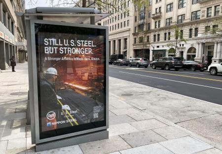 　ワシントンのバス停に掲示された、日本製鉄とＵＳスチールの合同広告＝９日（共同）